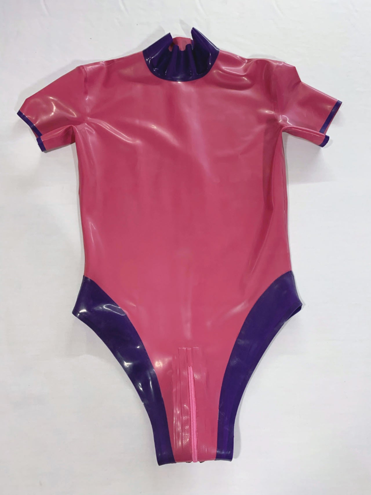 a pink latex bodysuit