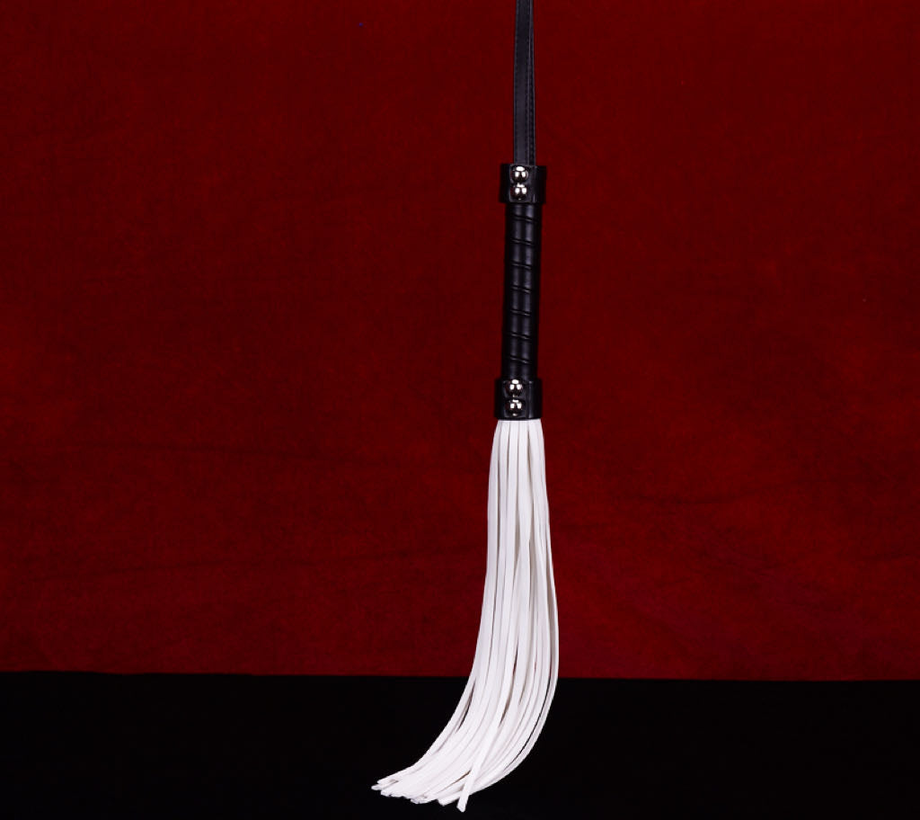 a white bdsm whip flogger