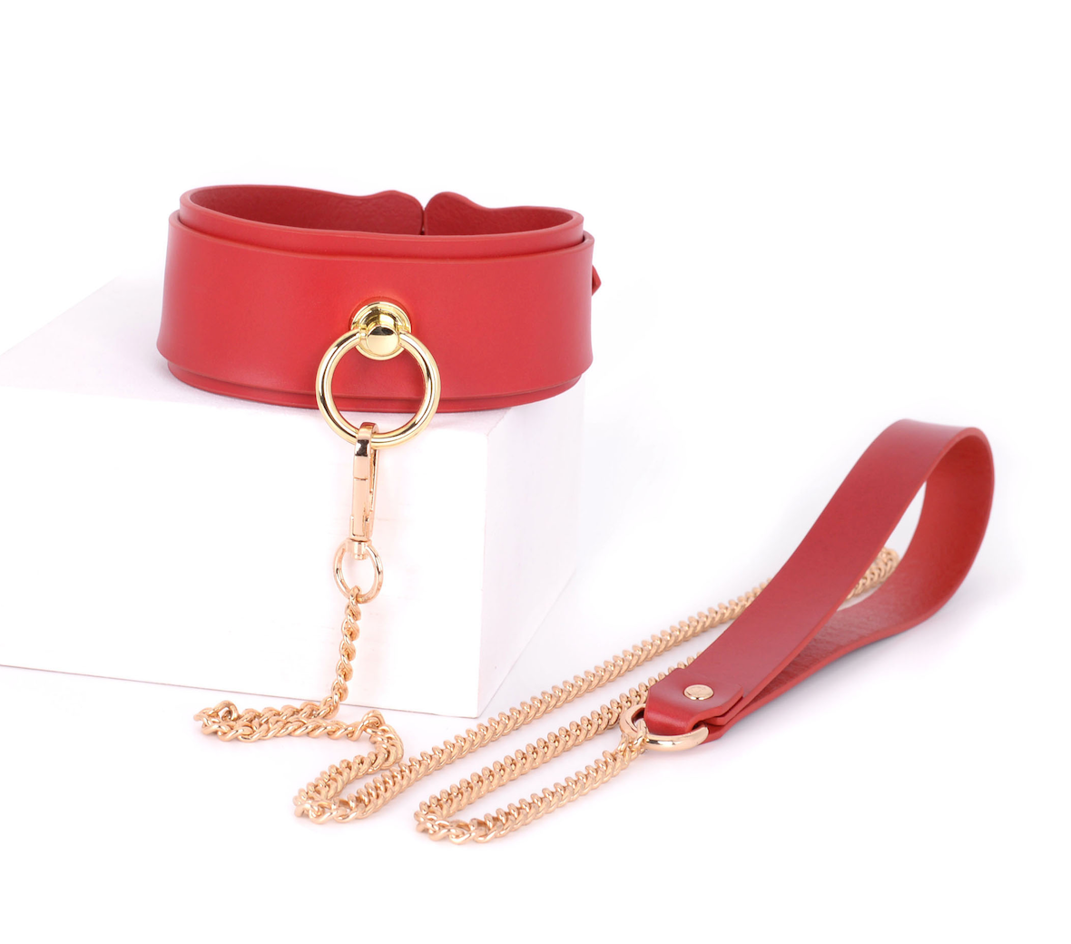 a red leather bondage collar and leash set