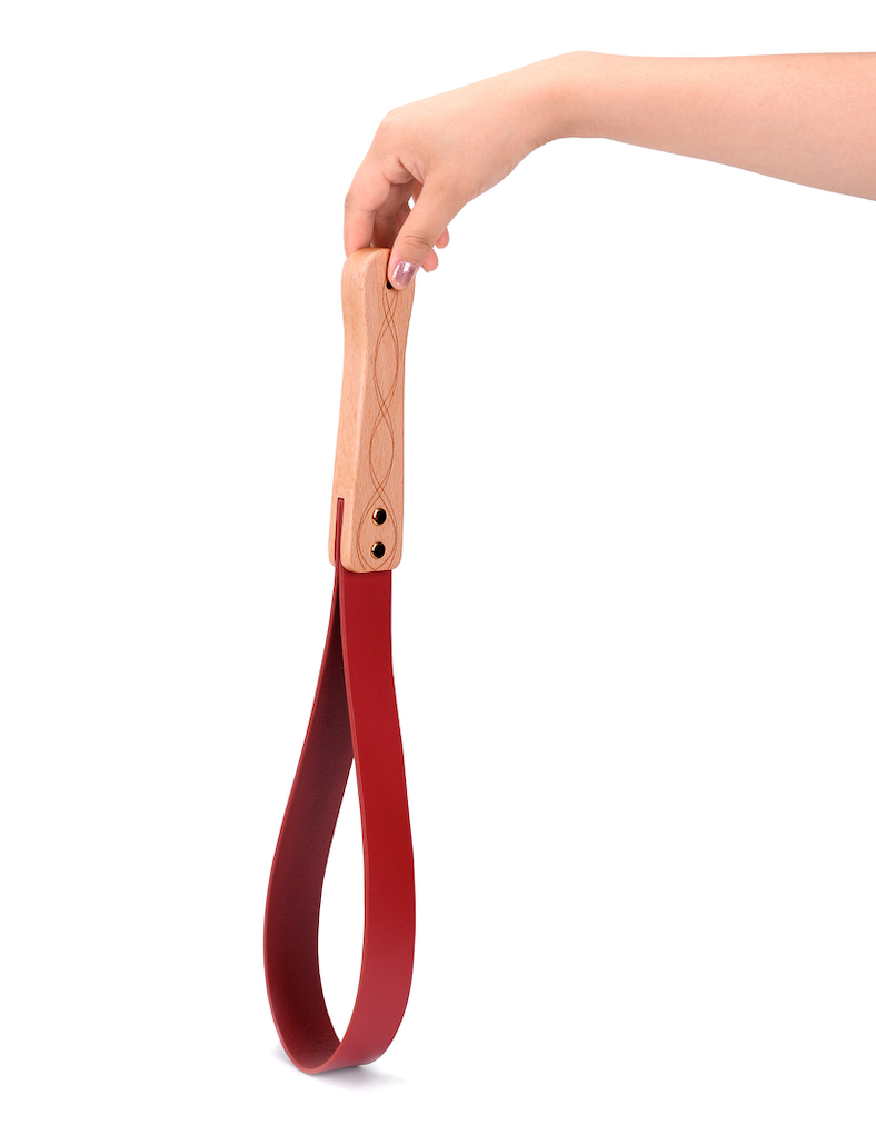 a red Spanking Paddles for Adults with wood handle