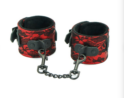 A pair of Red Leather Handcuffs with a chain link connection